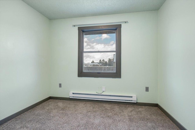 carpeted spare room featuring a textured ceiling and baseboard heating