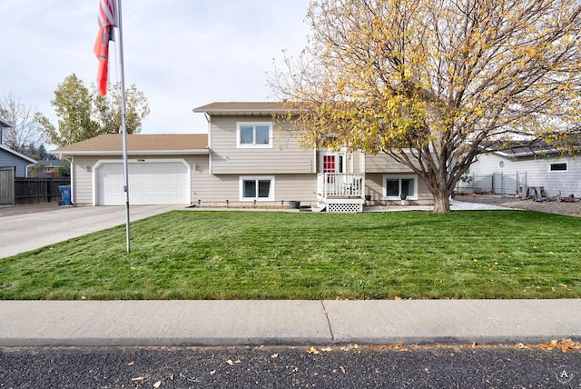 split foyer home featuring a garage and a front lawn