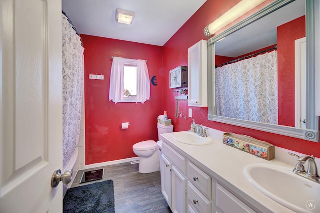 full bathroom with shower / bath combination with curtain, wood-type flooring, vanity, and toilet