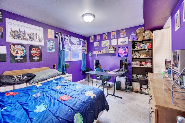 bedroom with light colored carpet and a textured ceiling