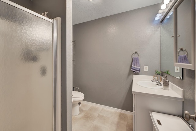 bathroom featuring vanity, toilet, a textured ceiling, and a shower with shower door