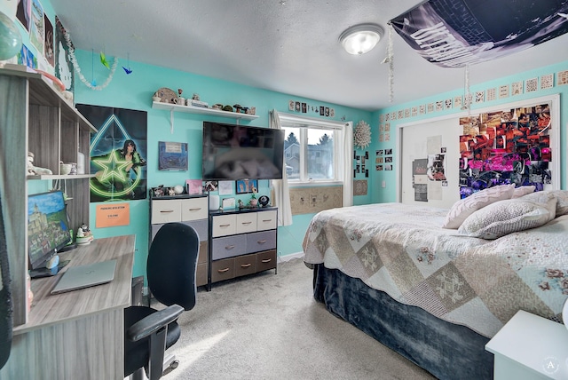 carpeted bedroom featuring a textured ceiling