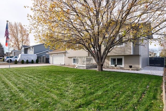 view of front facade with a wooden deck, a garage, and a front lawn