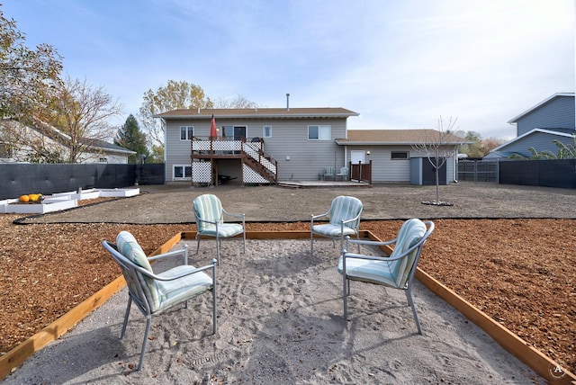 back of house featuring a patio area and a deck