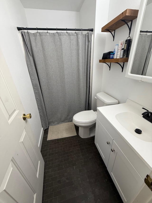 bathroom featuring vanity, a shower with shower curtain, and toilet