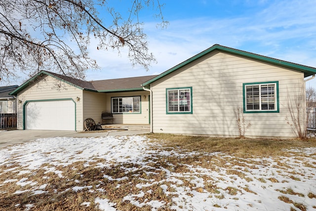 single story home with concrete driveway and a garage