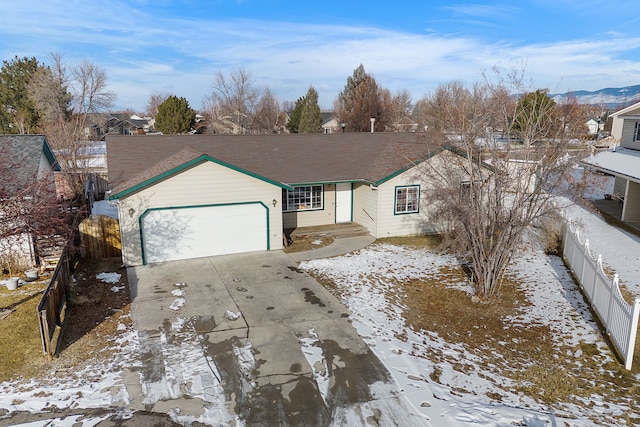 single story home featuring fence, concrete driveway, and a garage