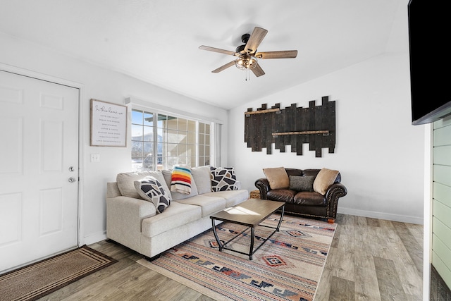 living room featuring baseboards, ceiling fan, lofted ceiling, and wood finished floors