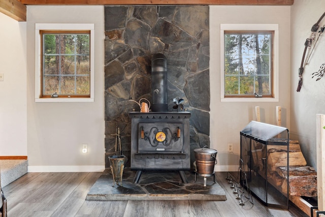 interior details with wood-type flooring and a wood stove