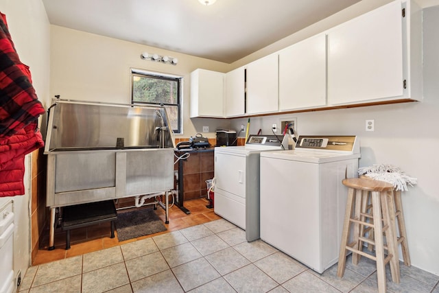 laundry area with cabinets, washer and dryer, and light tile patterned floors