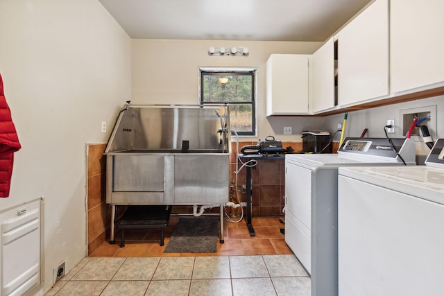 laundry room featuring cabinets, washer and clothes dryer, sink, and light tile patterned floors