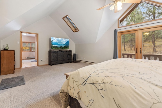 bedroom featuring ceiling fan, light colored carpet, lofted ceiling with skylight, and a baseboard heating unit