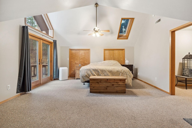 bedroom featuring ceiling fan, lofted ceiling with skylight, light carpet, access to outside, and french doors