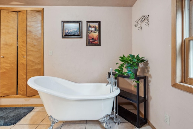 bathroom with tile patterned flooring and a tub