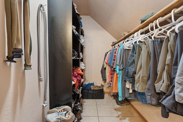 walk in closet featuring lofted ceiling and tile patterned floors