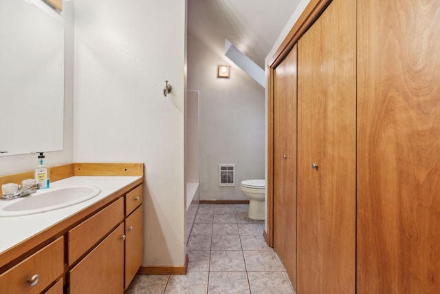 bathroom with vanity, toilet, and a bath