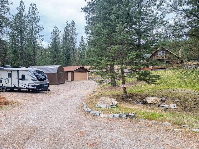 view of front of house with a garage and a storage unit