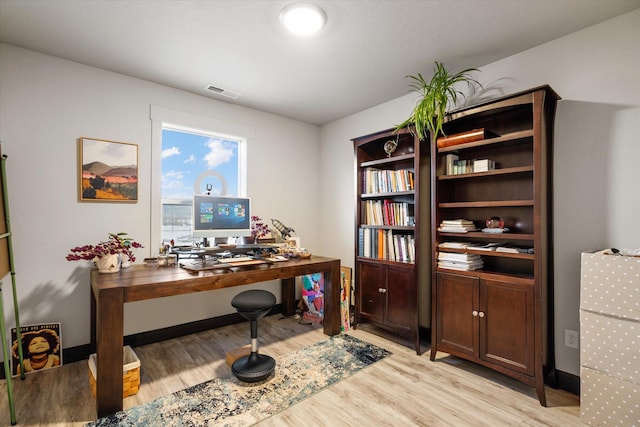 office space with light hardwood / wood-style flooring