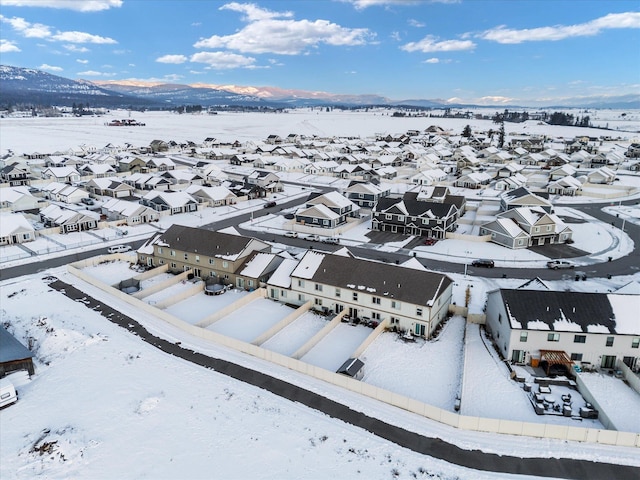 snowy aerial view with a mountain view