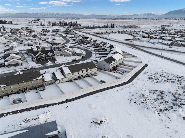 snowy aerial view with a mountain view