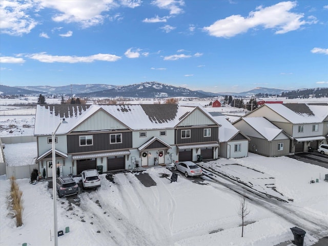 snowy aerial view with a mountain view