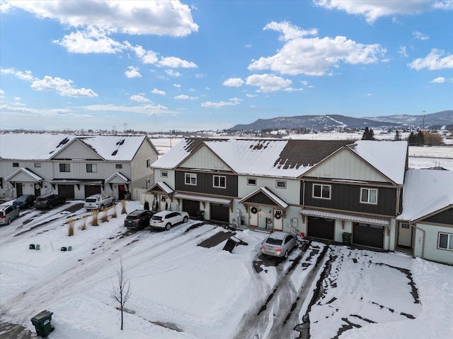 snowy aerial view featuring a mountain view