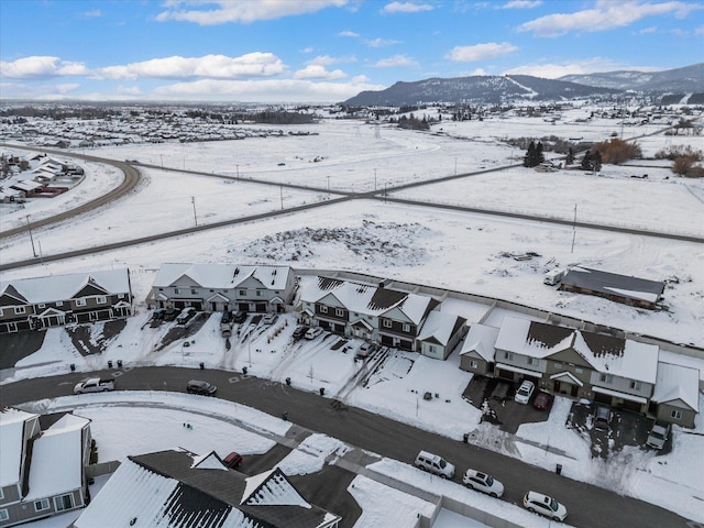 snowy aerial view with a mountain view