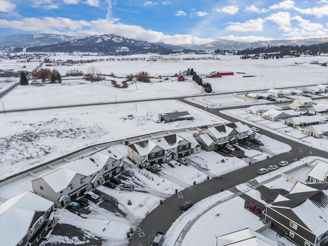 snowy aerial view featuring a mountain view