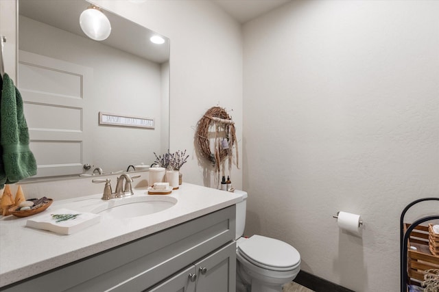 bathroom featuring vanity and toilet