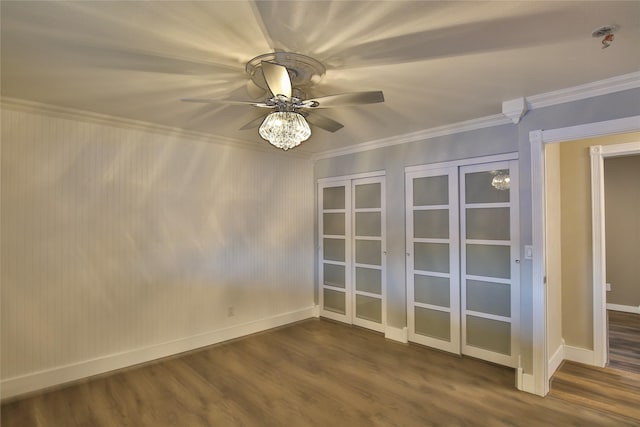 spare room with ornamental molding, dark wood-type flooring, and ceiling fan