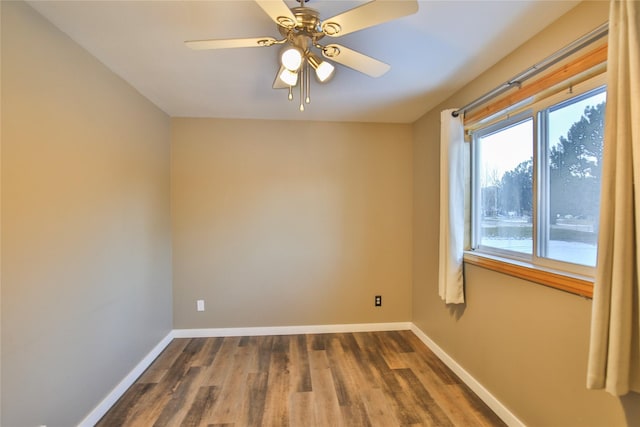 unfurnished room with dark wood-type flooring and ceiling fan