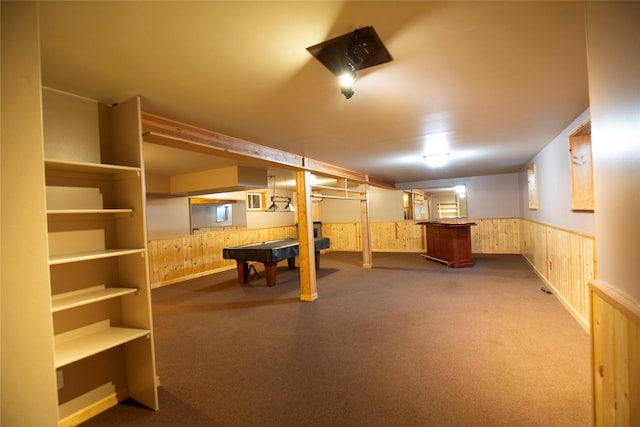 basement featuring carpet flooring, bar area, wooden walls, and billiards