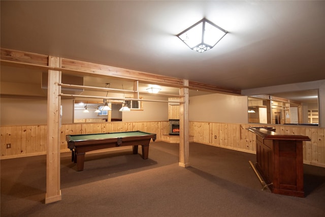 game room with dark colored carpet, wooden walls, pool table, and a fireplace