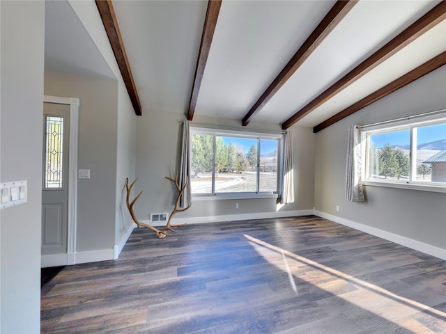 unfurnished living room with dark hardwood / wood-style floors and vaulted ceiling with beams