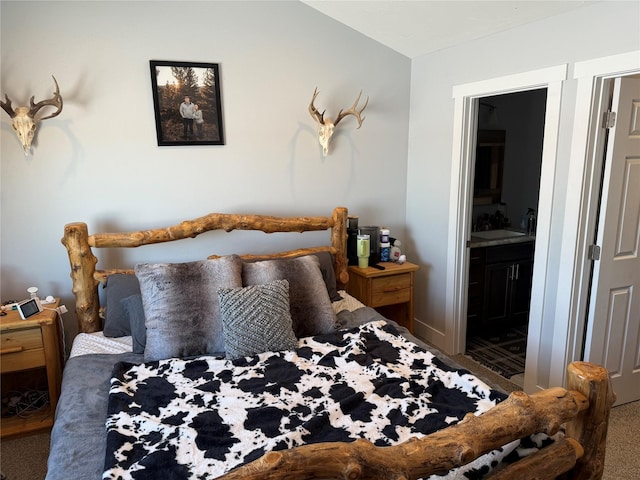 carpeted bedroom featuring ensuite bathroom