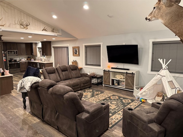 living room featuring vaulted ceiling and hardwood / wood-style floors