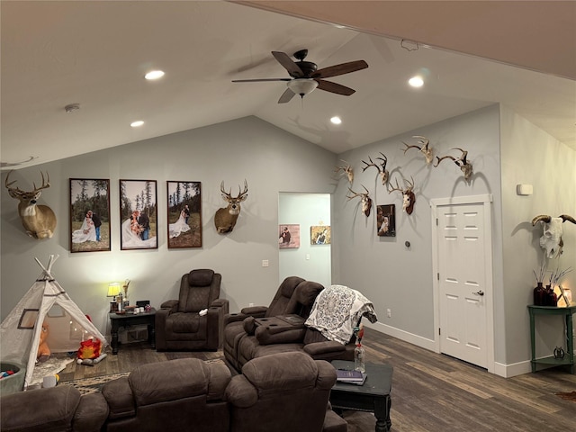 cinema room featuring dark hardwood / wood-style flooring, vaulted ceiling, and ceiling fan