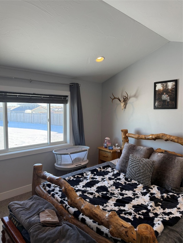 bedroom featuring vaulted ceiling and carpet floors