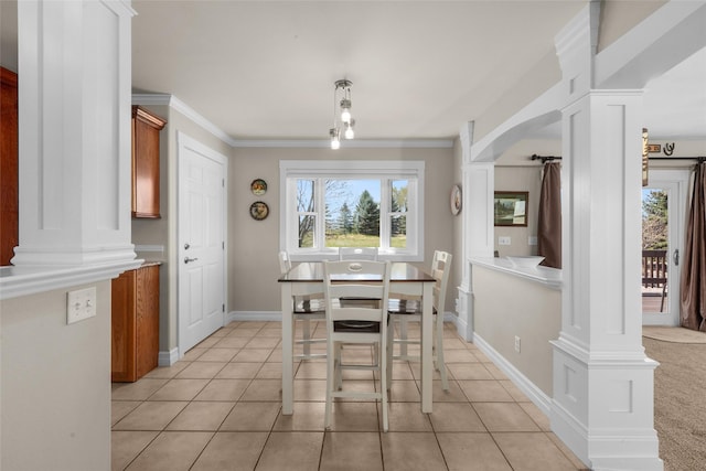 tiled dining area featuring crown molding and ornate columns