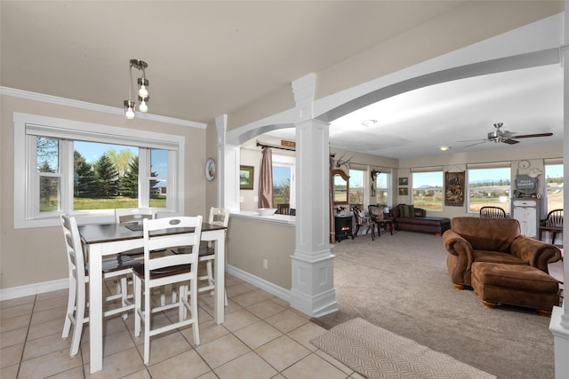 dining area featuring ornate columns, ornamental molding, light tile patterned floors, and ceiling fan