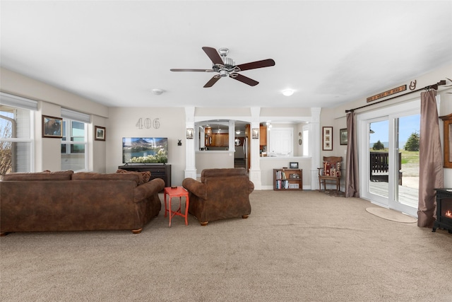 carpeted living room featuring ceiling fan