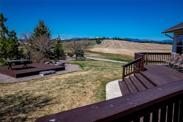 view of yard with a rural view and a deck