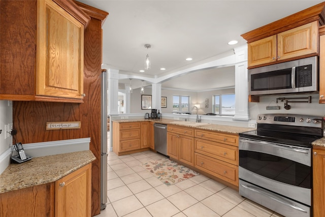 kitchen featuring sink, stainless steel appliances, light stone countertops, light tile patterned flooring, and ornate columns