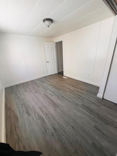 empty room featuring dark wood-type flooring