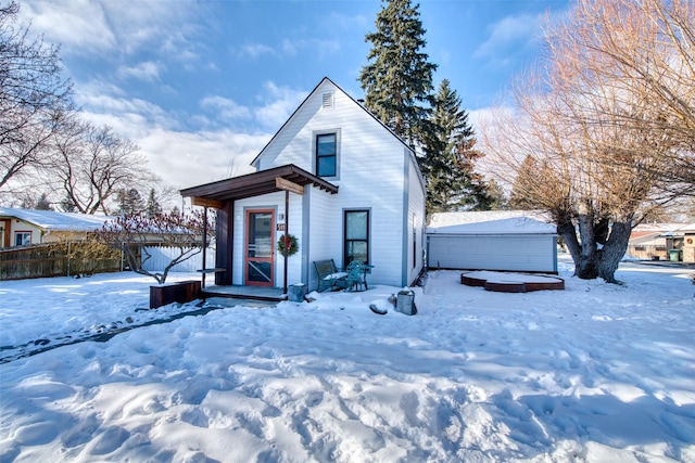 view of front of property featuring a storage shed