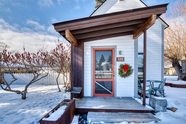 view of snow covered property entrance