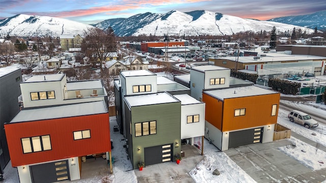 snowy aerial view featuring a mountain view