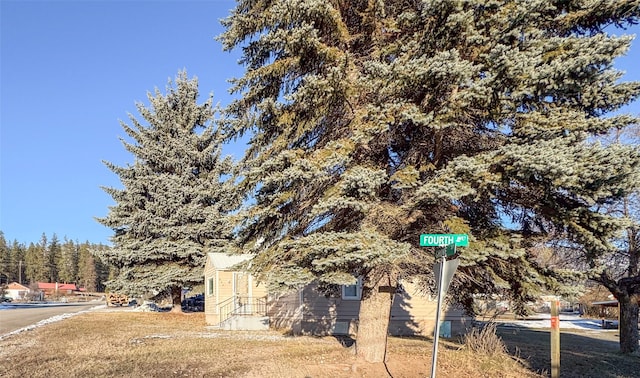 view of side of property with a yard