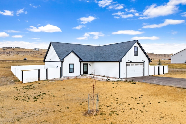 modern inspired farmhouse with a garage