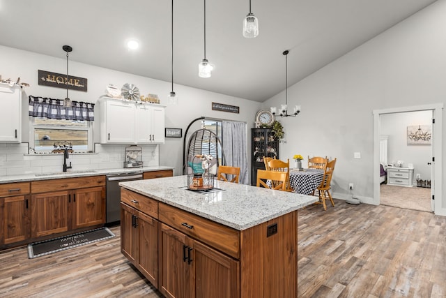 kitchen featuring white cabinetry, stainless steel dishwasher, sink, and backsplash